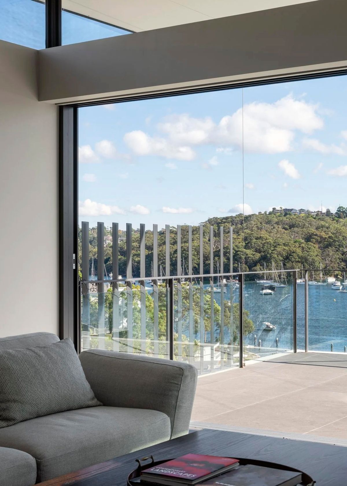 Living room at Shellbank House looking over the terrace to Middle Harbour