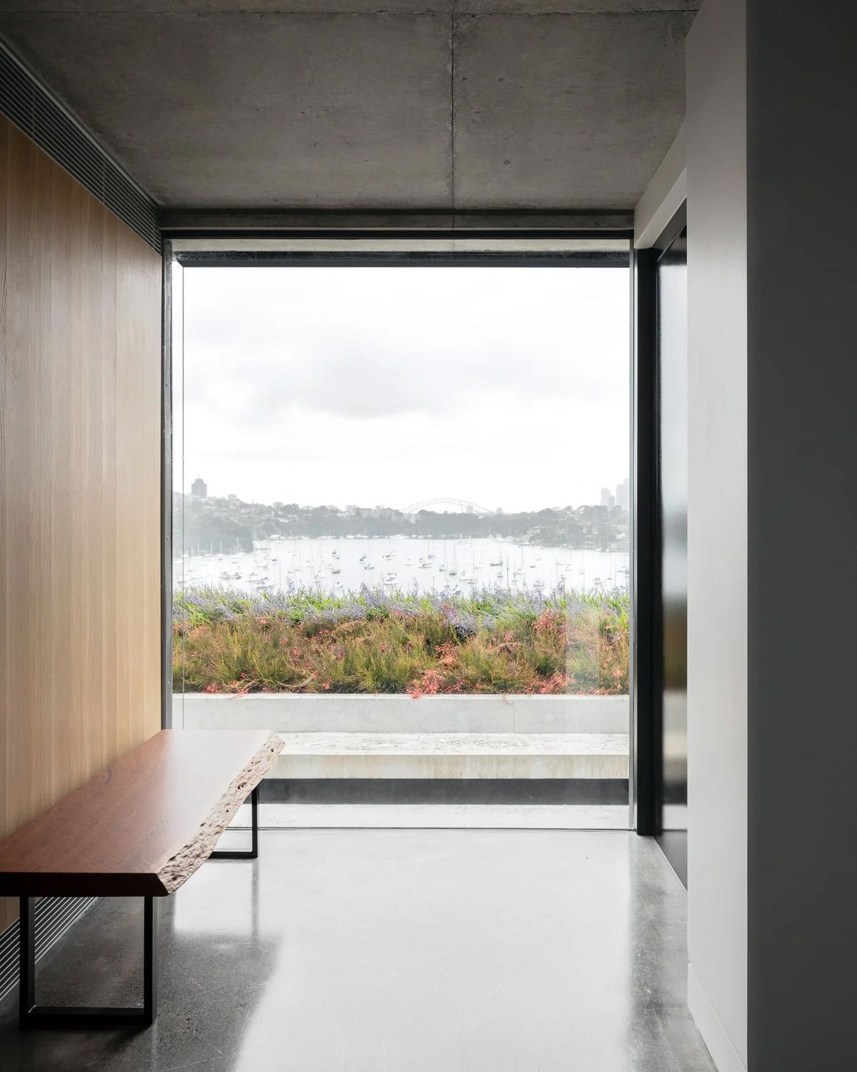 Window seat with a timber bench looking over the bay at Bay House