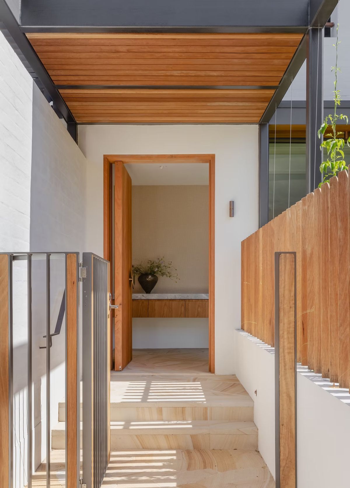 Timber screened entry stair at Casa Risata with a timber ceiling and sandstone steps