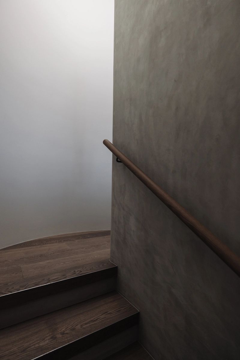 Timber handrail on a rendered stair wall