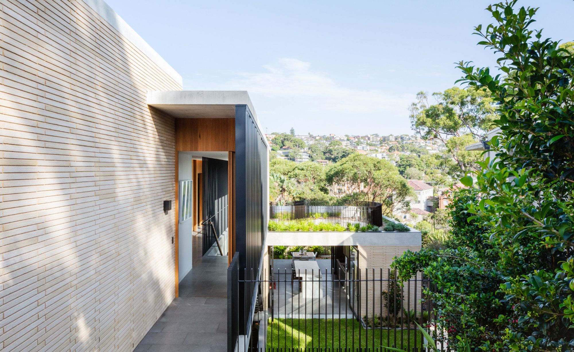Timber and brick side entry at Balmoral House with the harbour suburbs beyond