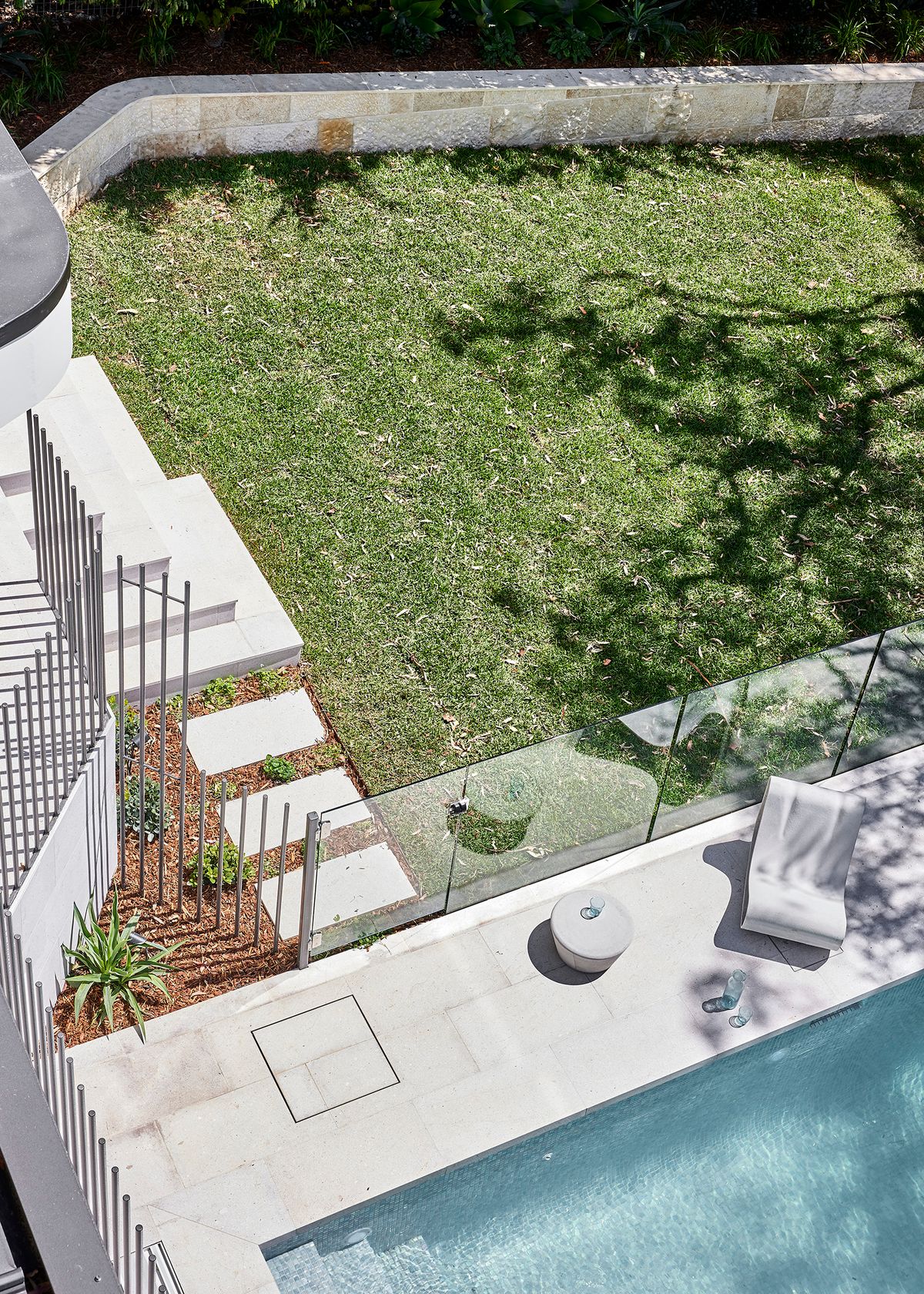 Lawn, pool and paved terrace at Cobbittee House seen from above