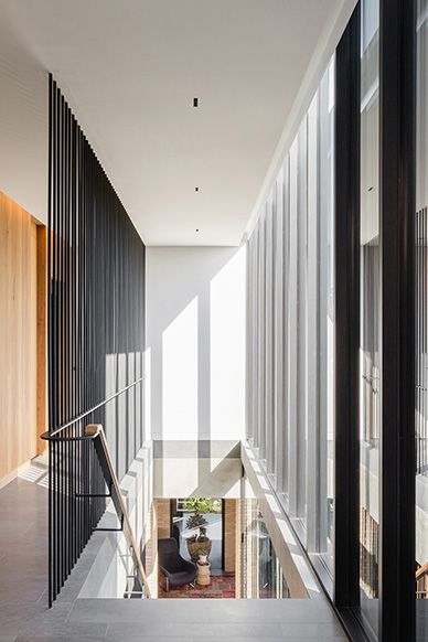 Upper level walkway with steel battens looking down to the living room