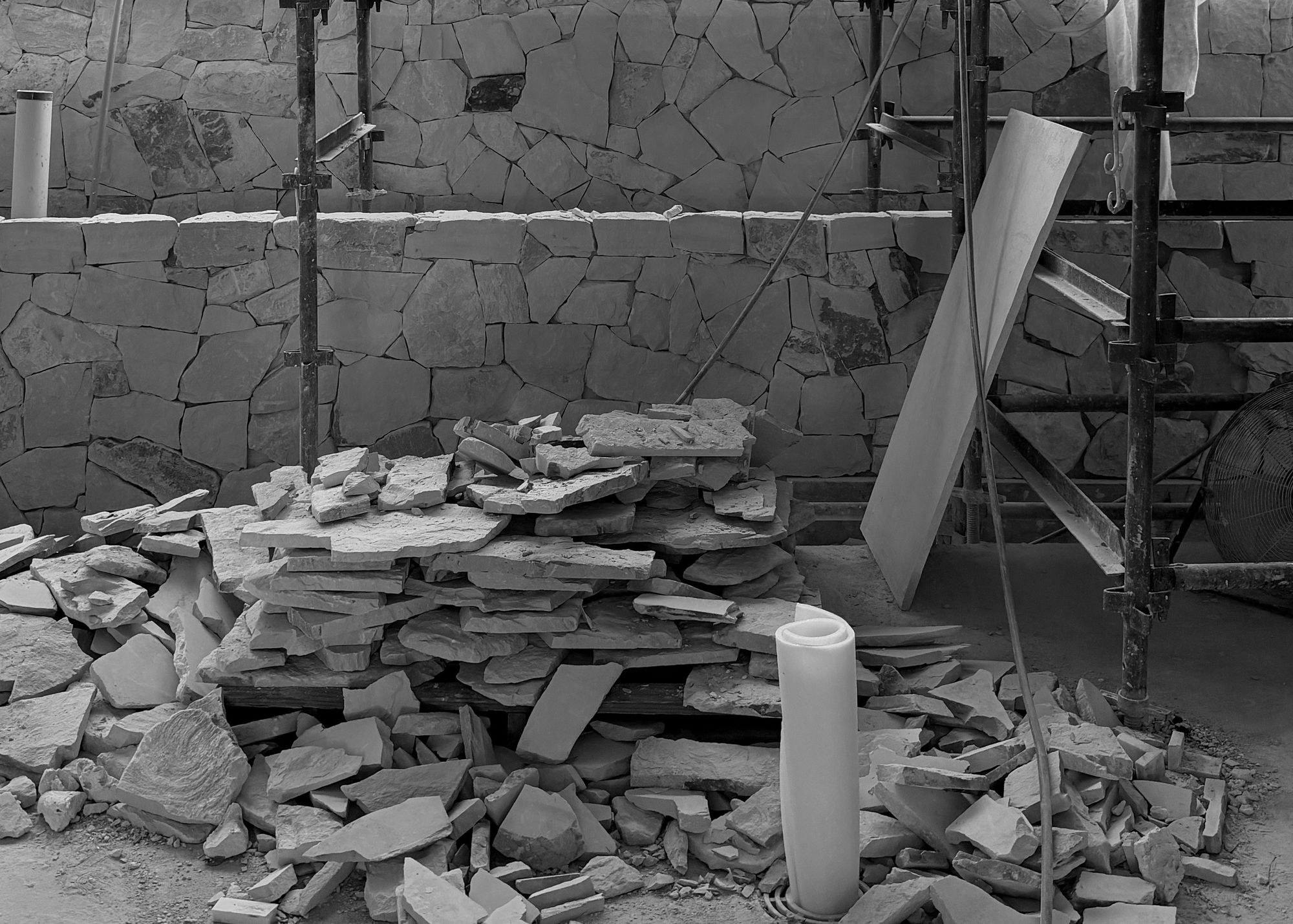 Sandstone wall under construction at Esplanade, with stacked stone and scaffolding