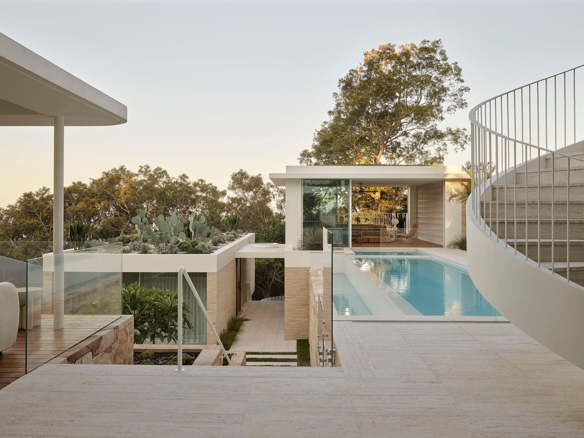 Pool and glass balustrade at Breeze House with the spiral stair beyond