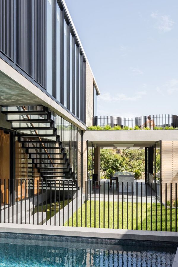 Balmoral House courtyard with a pool, open steel stair and an upper level of dark battens