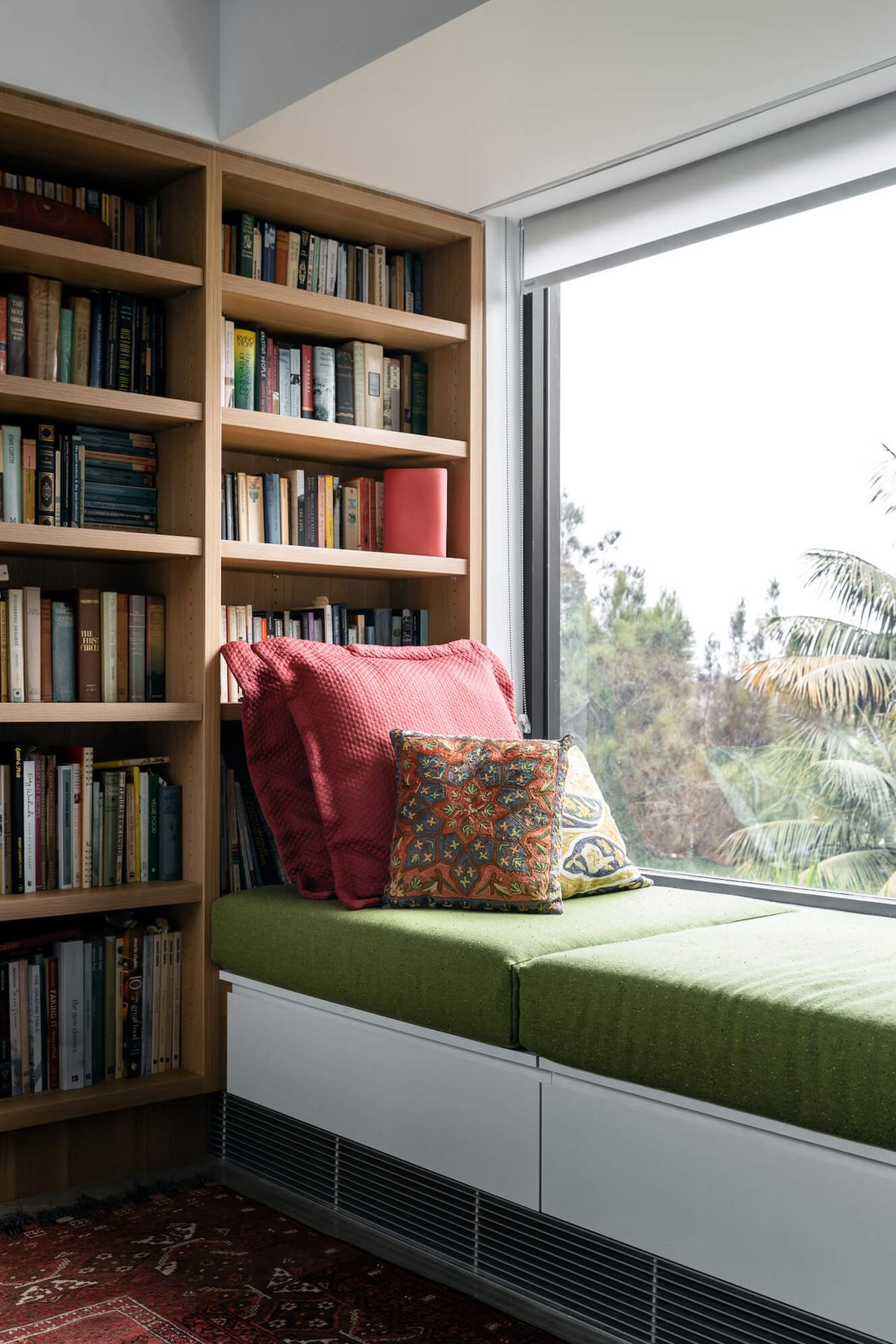 Window seat in the timber lined library at Bay House, looking to the trees