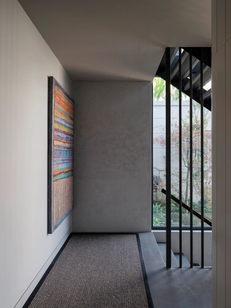 Landing at Shellbank House with a striped abstract artwork and a stair down to the garden