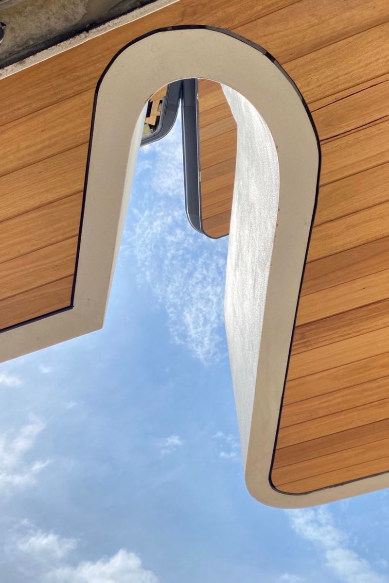 Arched timber soffit framing the sky at Casa Risata