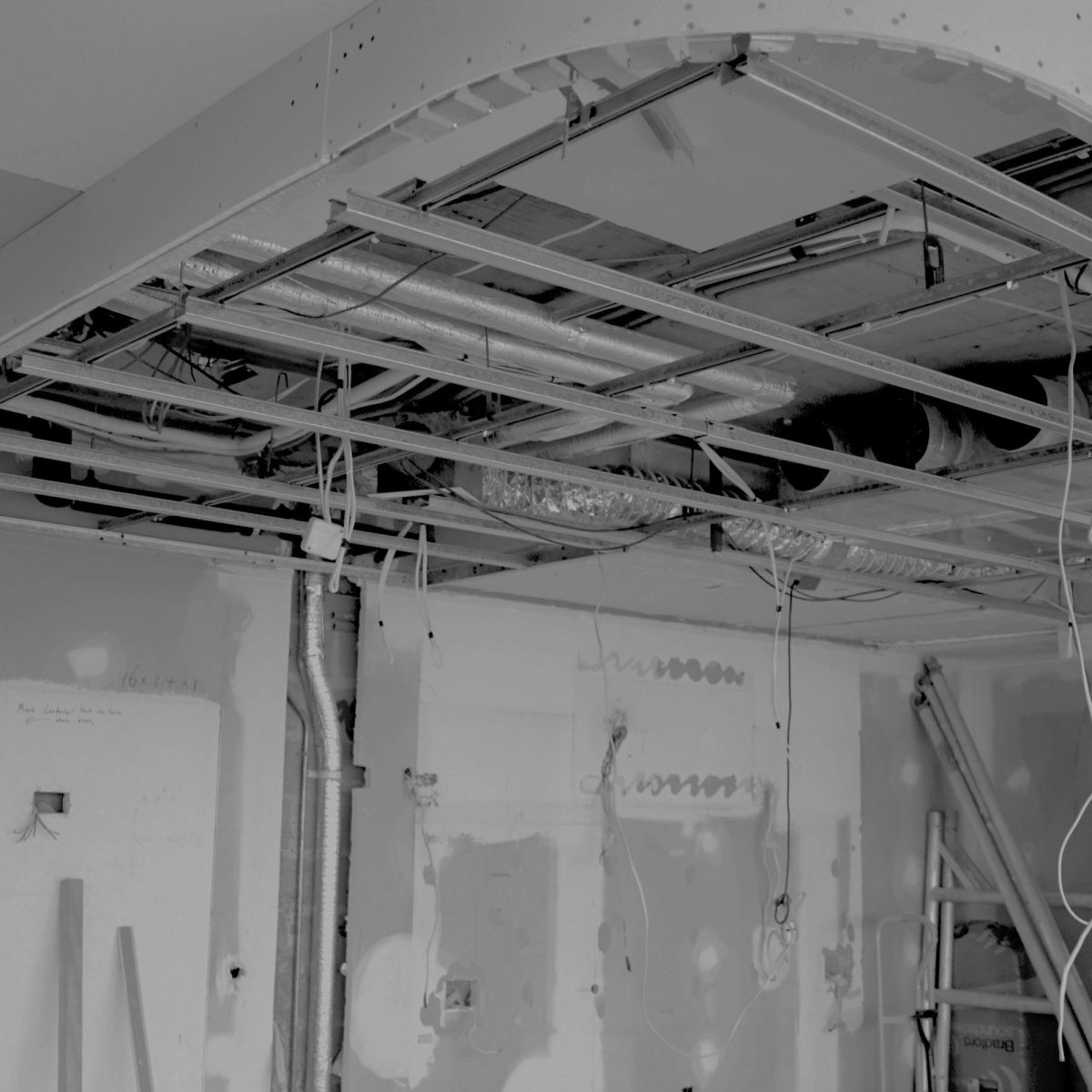 Ceiling services and steel framing exposed during construction at Elizabeth Bay