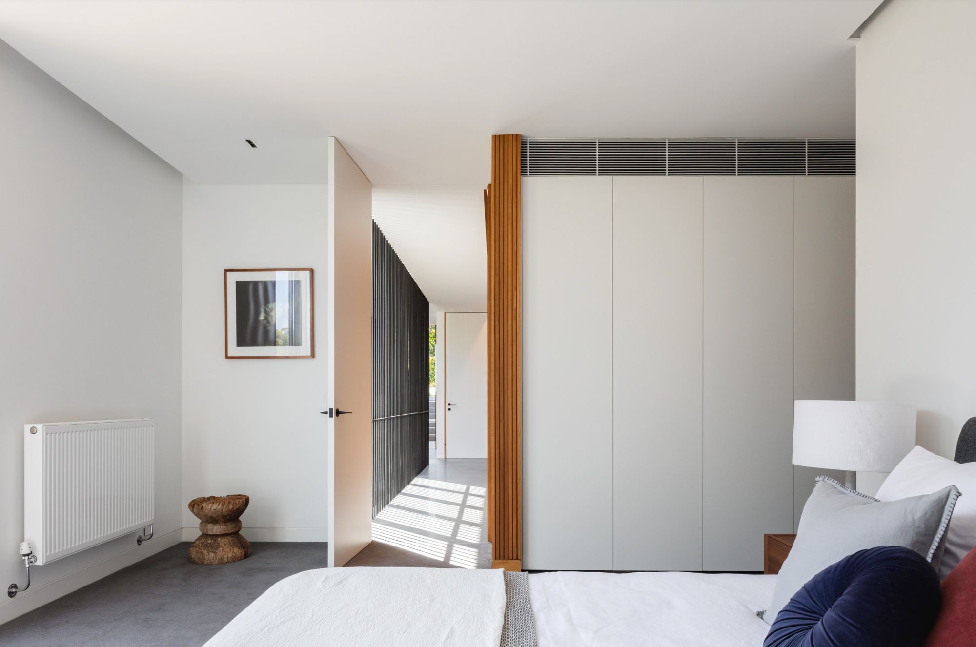 Bedroom at Balmoral House with white joinery and a timber framed doorway