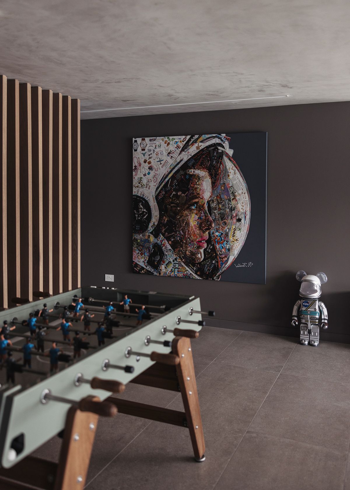 Games room at Shellbank with a table football, a large portrait artwork and timber battens