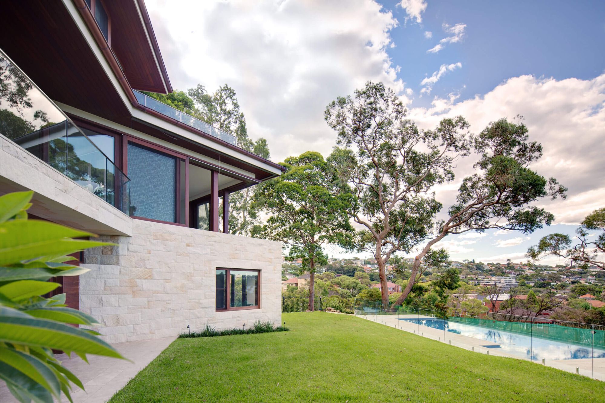 Lawn and pool at Quiet House with the house stepping down the site