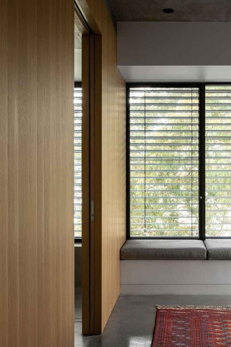 Timber lined window seat with louvre windows to the garden