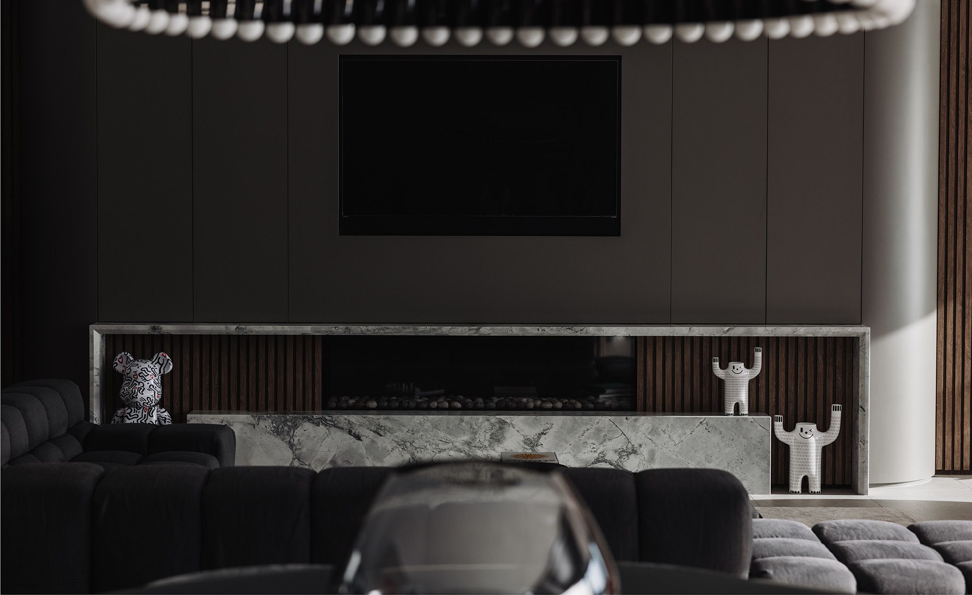 Living room with a marble fireplace hearth and a ring of pendant lights