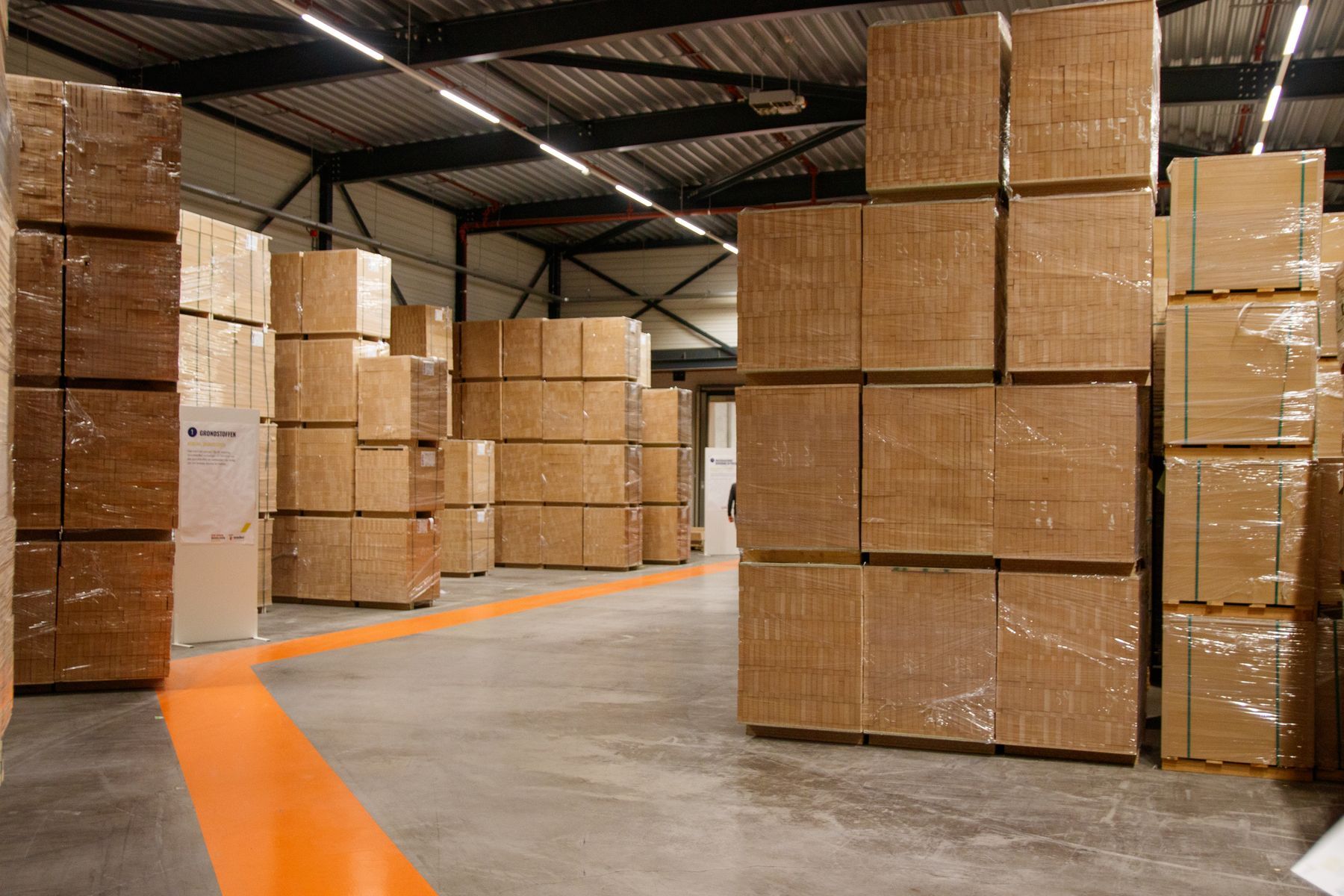 Rangées de cartons empilés dans un vaste entrepôt de stockage et de distribution