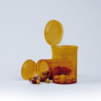 Two amber child resistant pop-top bottles filled with medications.