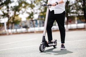 Lower body of a heavier person on an electric scooter. 