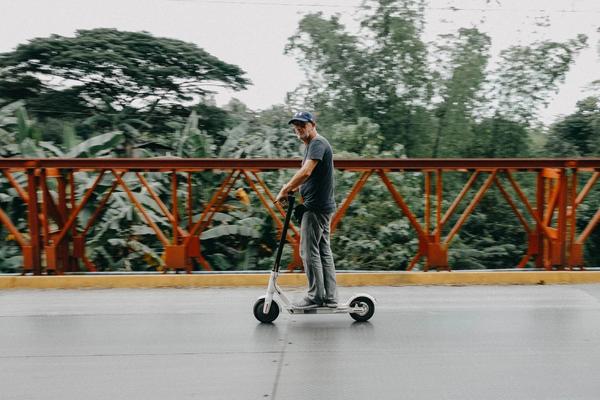 Man riding electric scooter to work