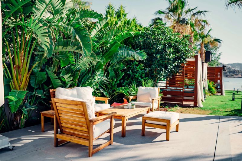 Outdoor garden furniture set with lots of greenery in the background