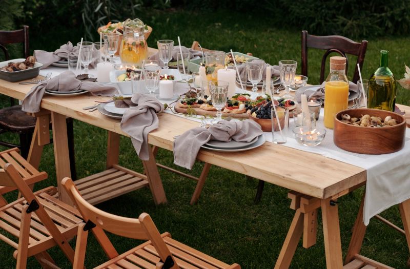 Full table of food, plates and glasses in the garden