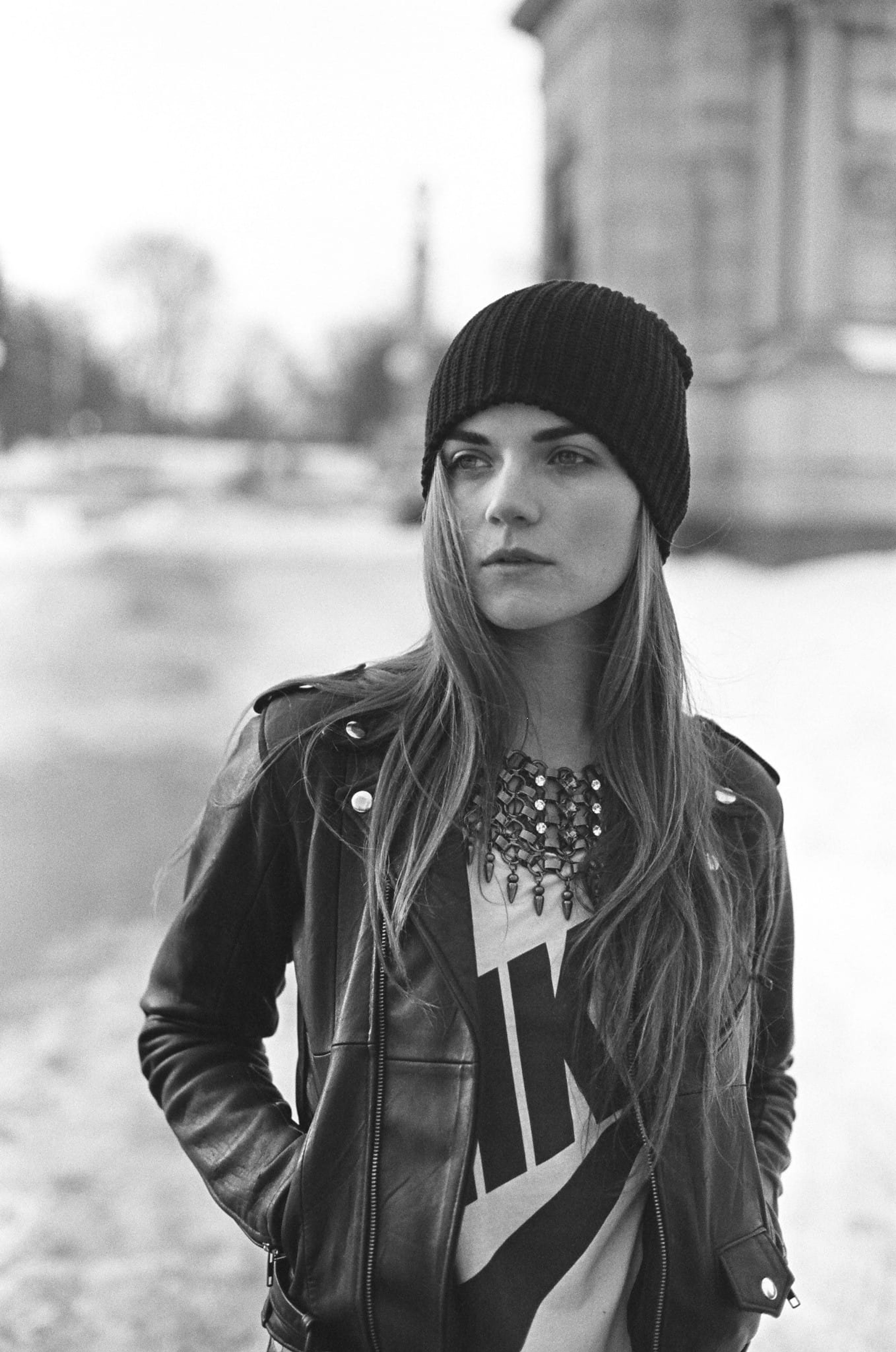 Dannijo: black-and-white portrait of a woman in a leather jacket and statement necklace