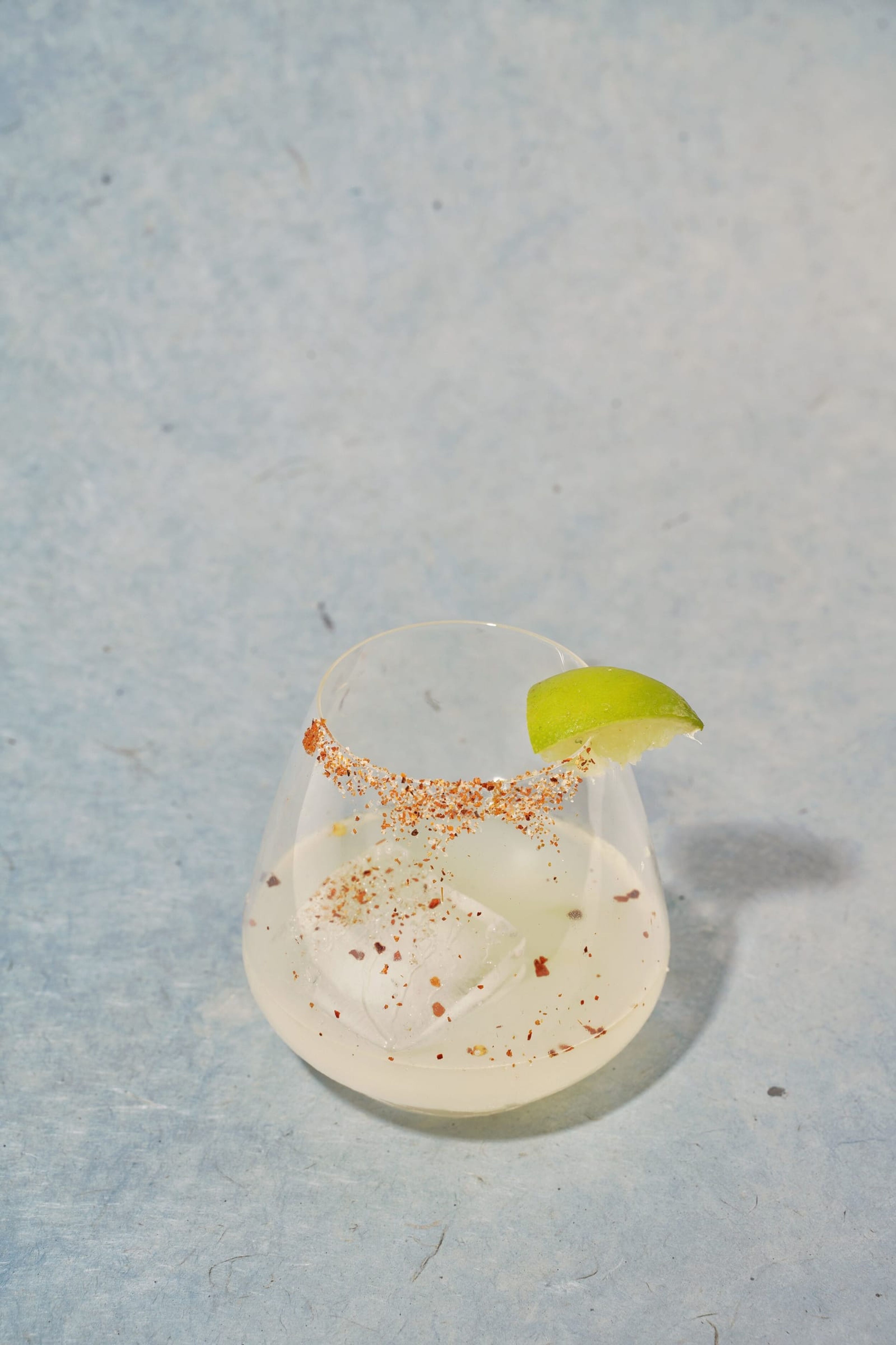 Margarita with a chili-salt rim and a lime wedge