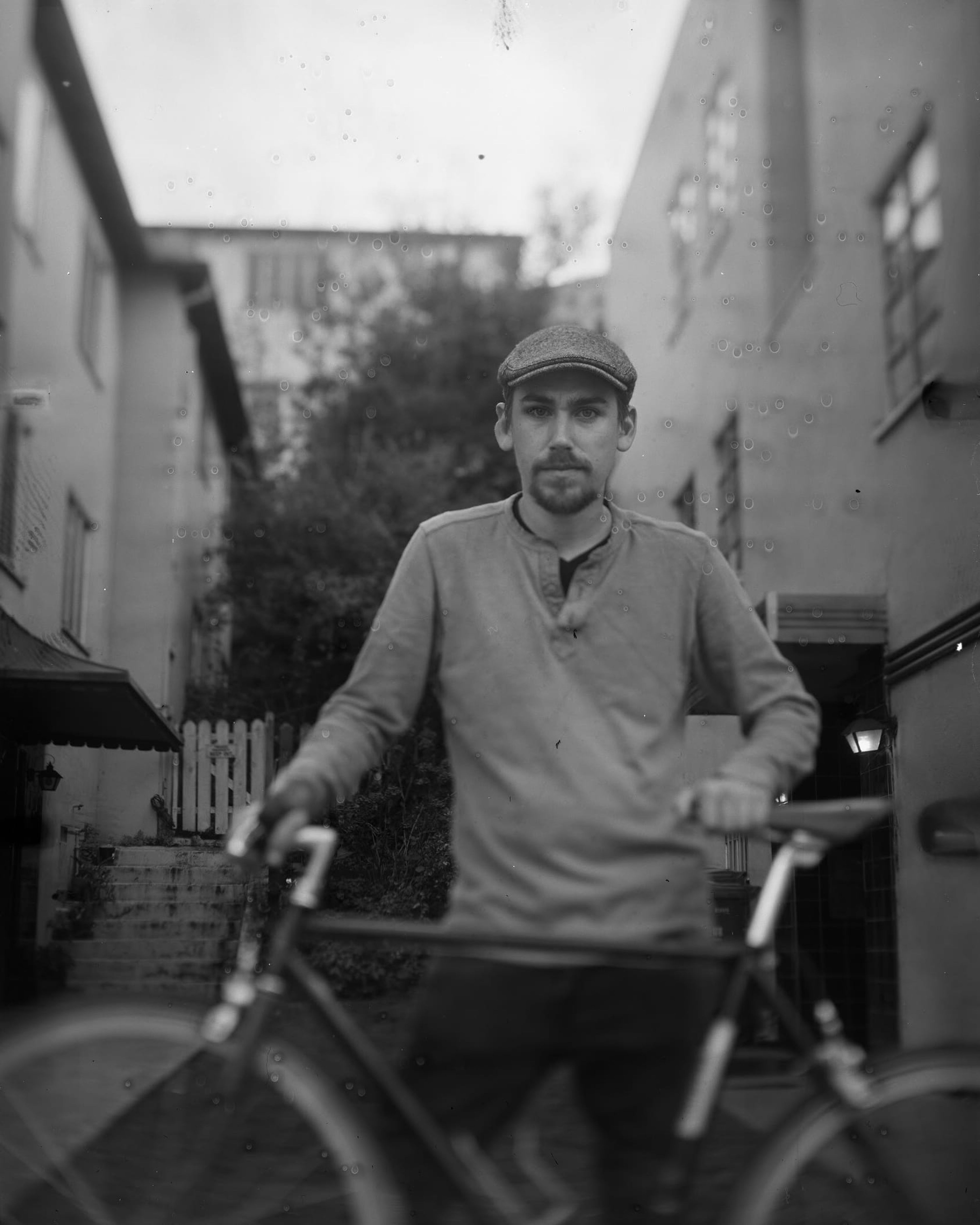 Black-and-white portrait of Austin with his bicycle