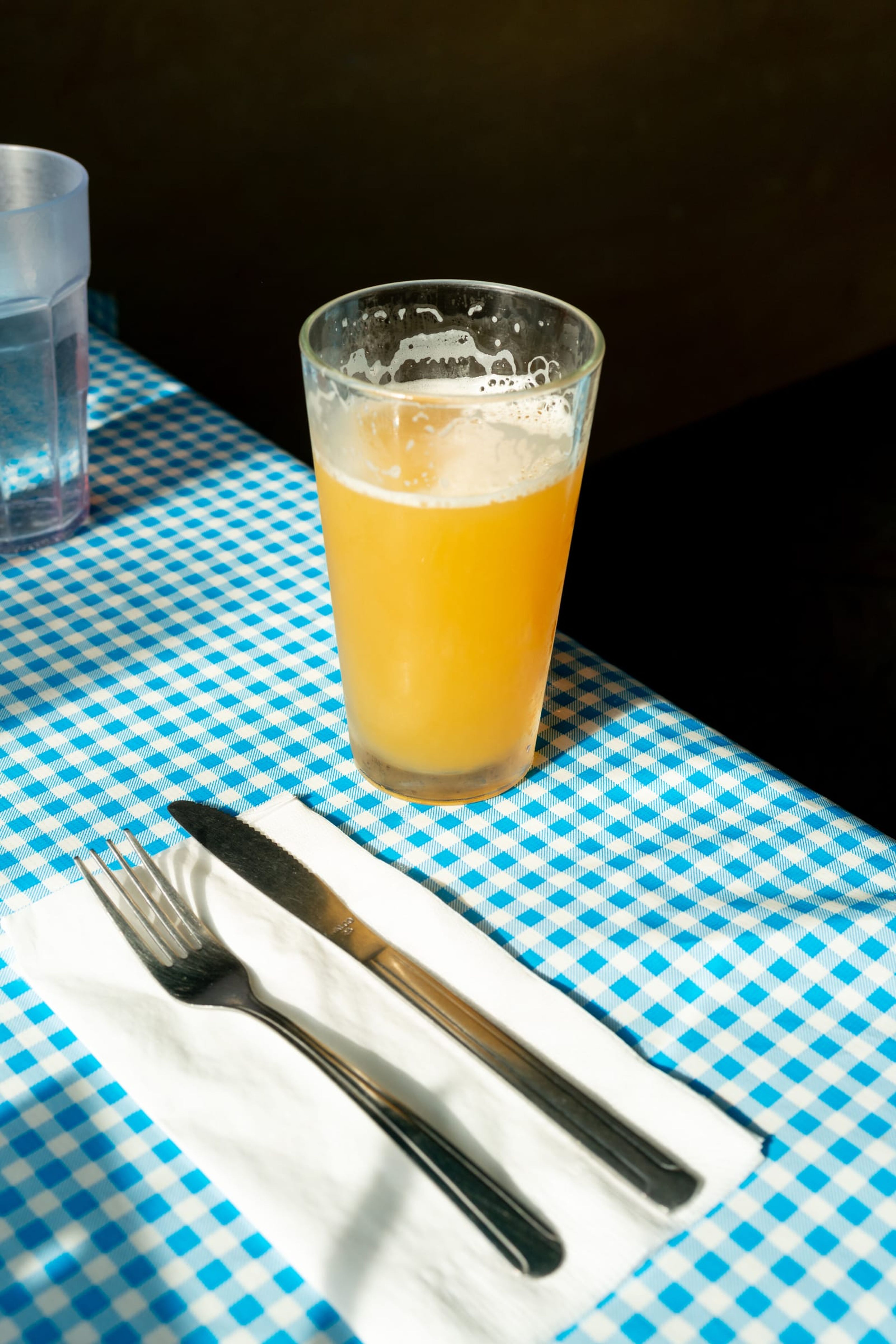 Glass of beer on a gingham tablecloth