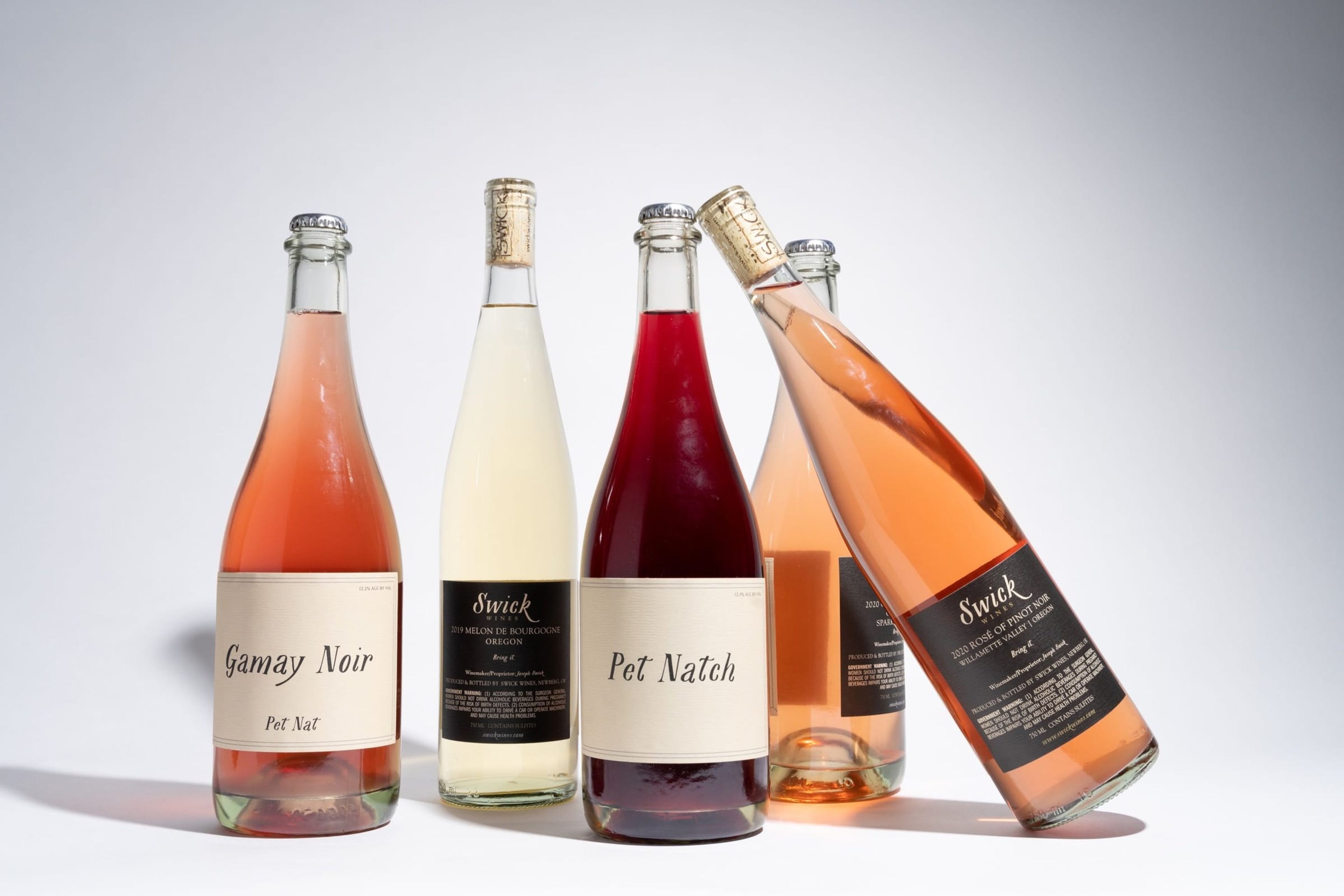 Swick and Pet Natch bottles grouped against white