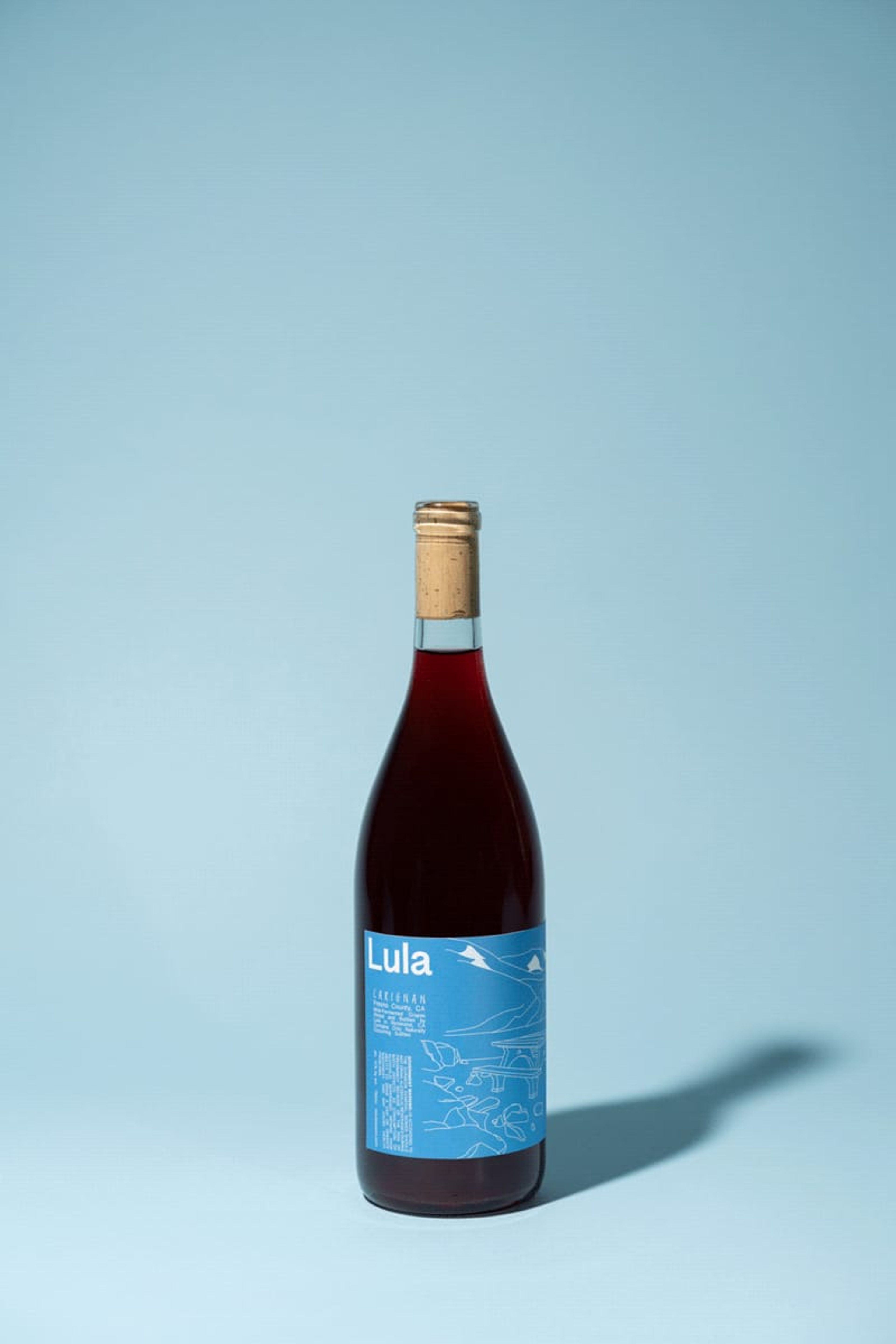 Bottle of Lula red wine on a pale blue backdrop