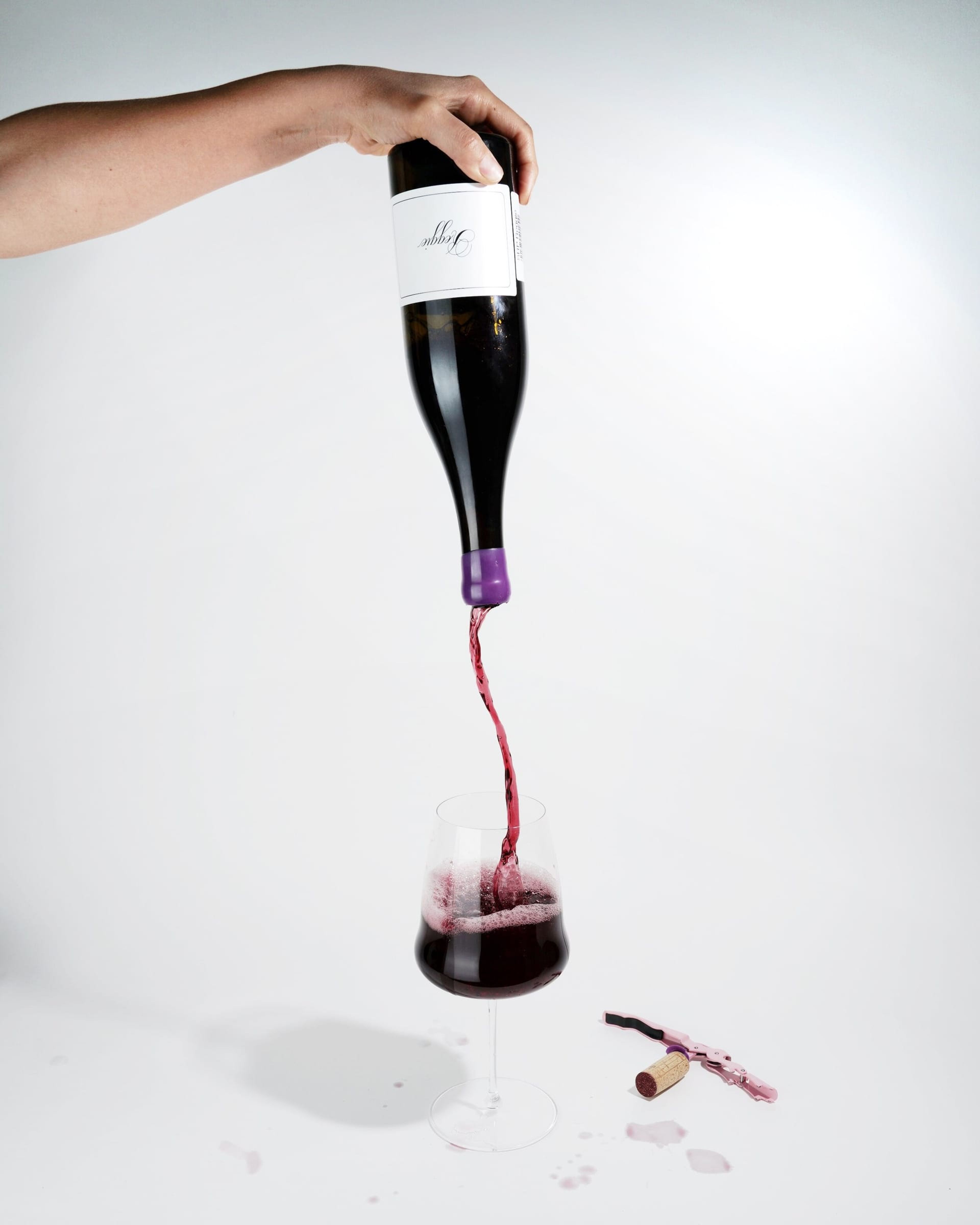 Wine pouring from an upturned bottle into a glass