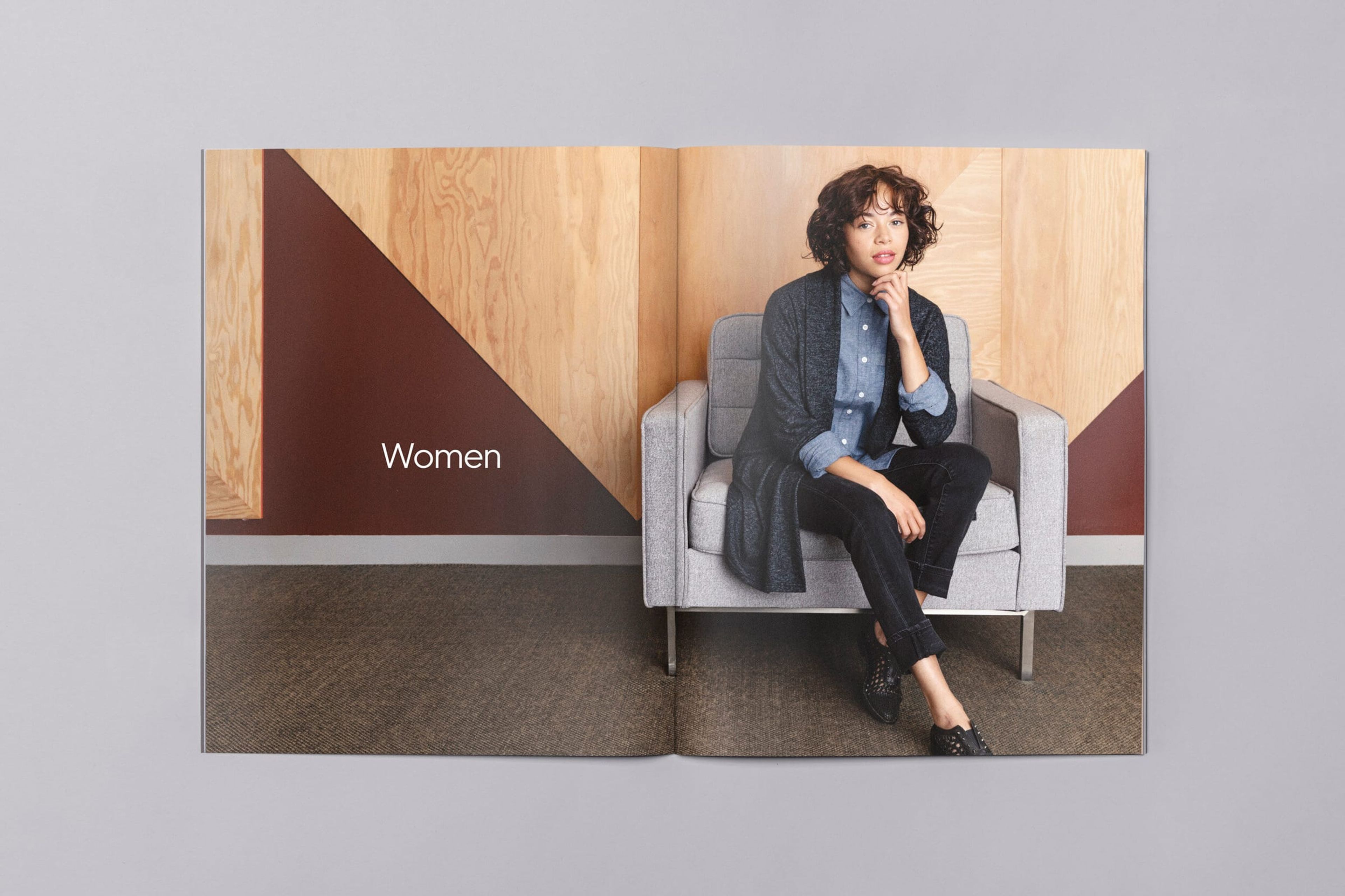 Lookbook “Women” spread: a woman in a cardigan seated in an armchair