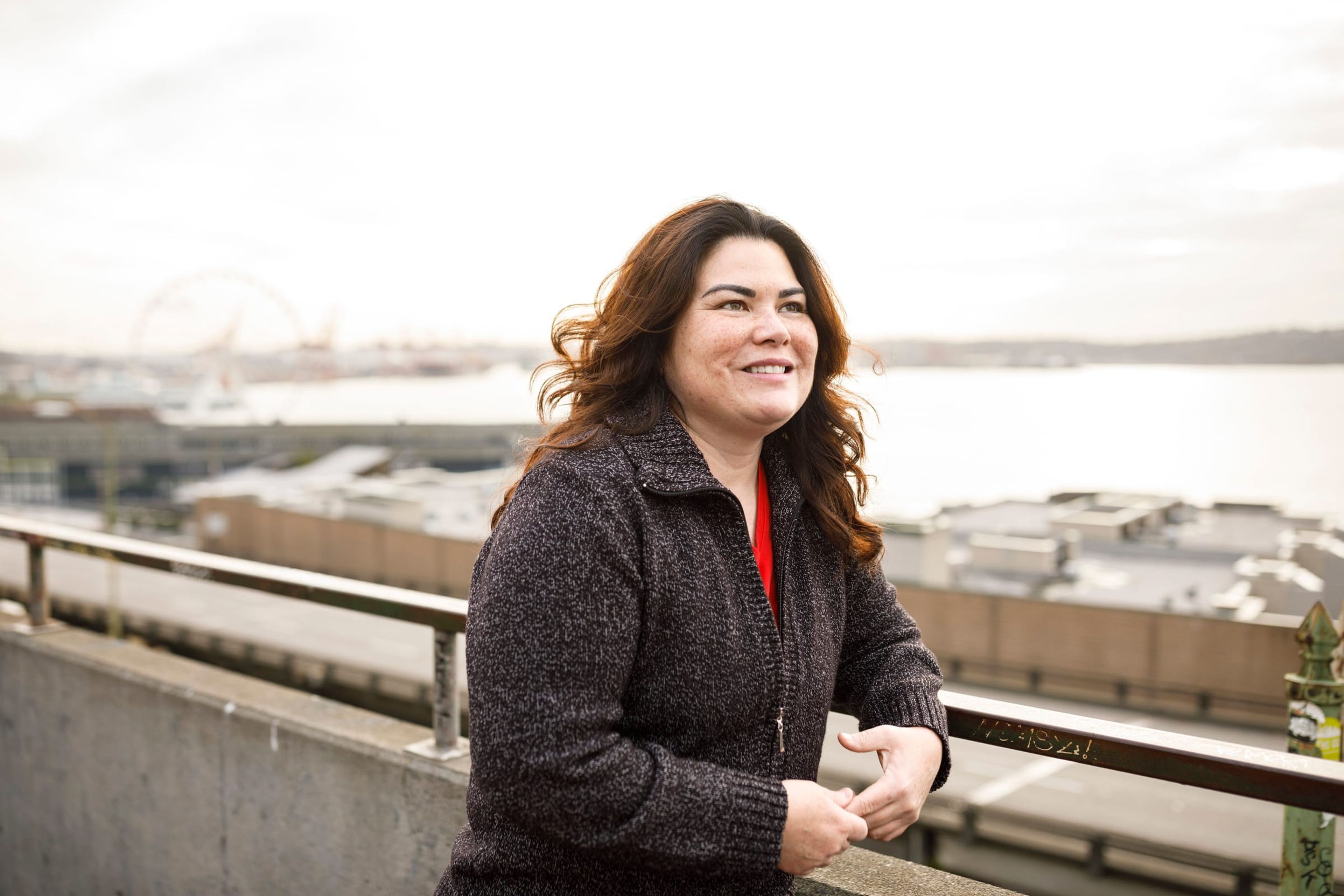 Woman at a railing above the Seattle waterfront