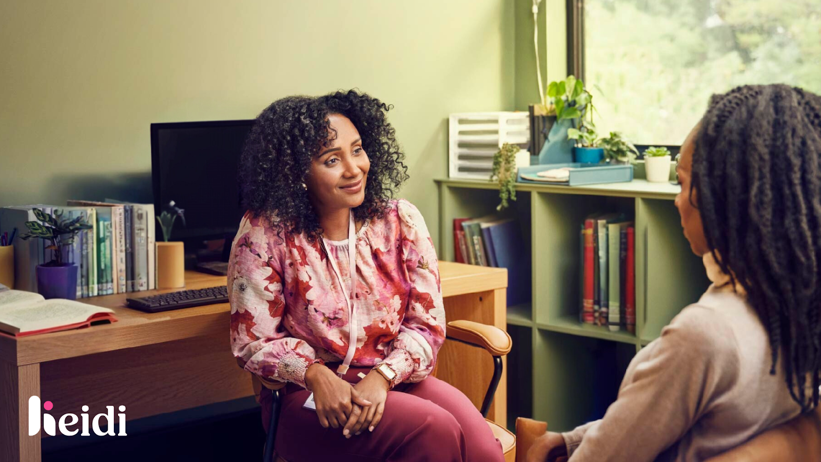 A clinician speaking with a patient during a consultation.