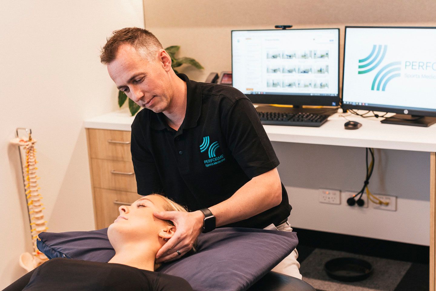 a man is giving a woman a head massage in a room .