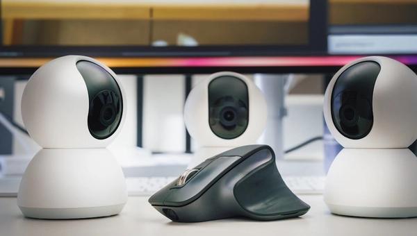 A group of three cameras sitting on top of a table