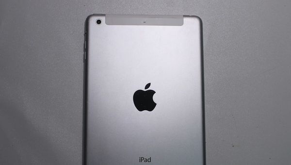 a silver ipad sitting on top of a table