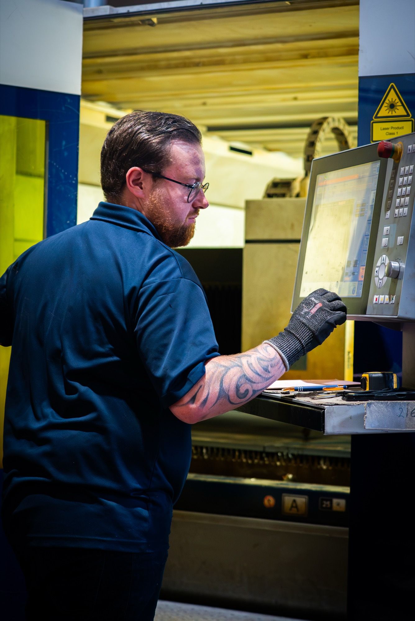 Operator programming a machine control panel