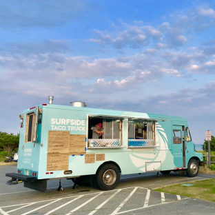 Grab a bite from the many food trucks stationed in the Surfside parking lot.