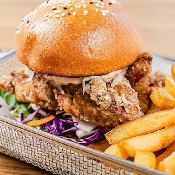 Karaage chicken in an artisan bread roll with pickles and yuzu mayo