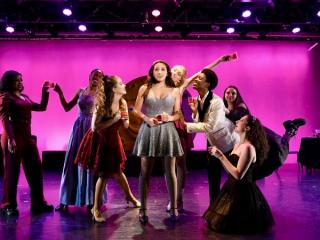 AMDA students performing on a purple stage.