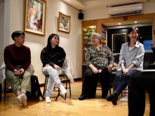 Four students discussing and sharing notes.