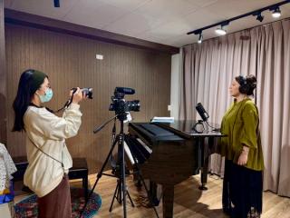 Student in a studio filming MV and vocal recording.