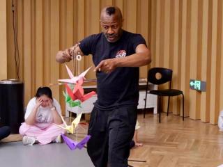 Omar教演員如何用道具鳥表演。