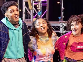 3 AMDA students performing on stage.