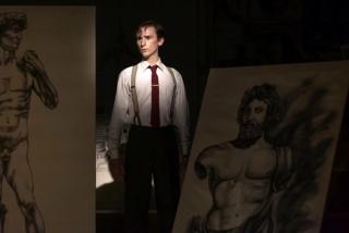 Rob standing between paintings.