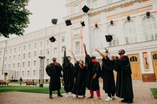 Group of students graduating in front of a European building.