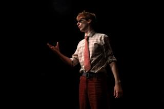 Rob in a red trousers on a stage.