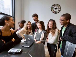 AMDA students practising around a piano.